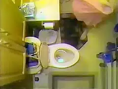 Naked maiden takes a piss in the bathroom