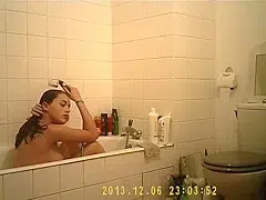 Brunette cutie enjoys a hot shower in the bathroom