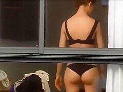 Spying on neighbour undressing.